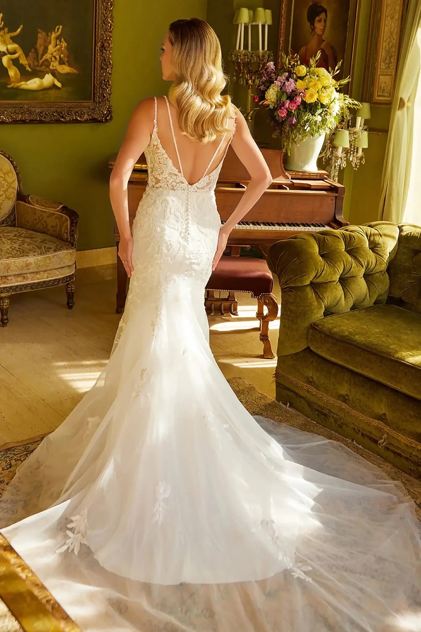 Back full-length view showcasing the fitted flared skirt as it flows into a shimmering train, emphasizing the sleek transition from the waist to the hem.