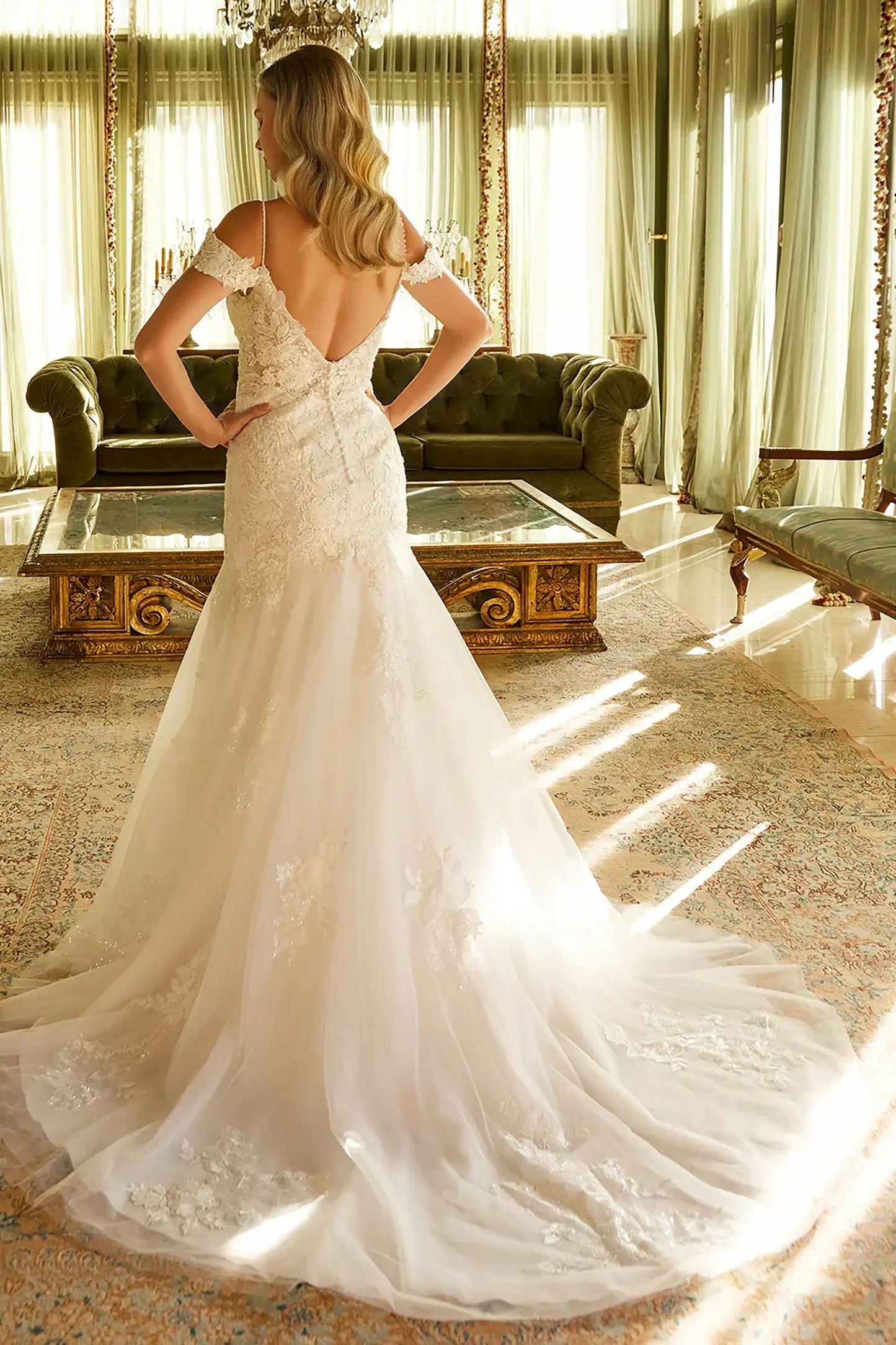 Back full-length view showcasing the dramatic flared mermaid skirt and the long, graceful sweep of the bridal train.
