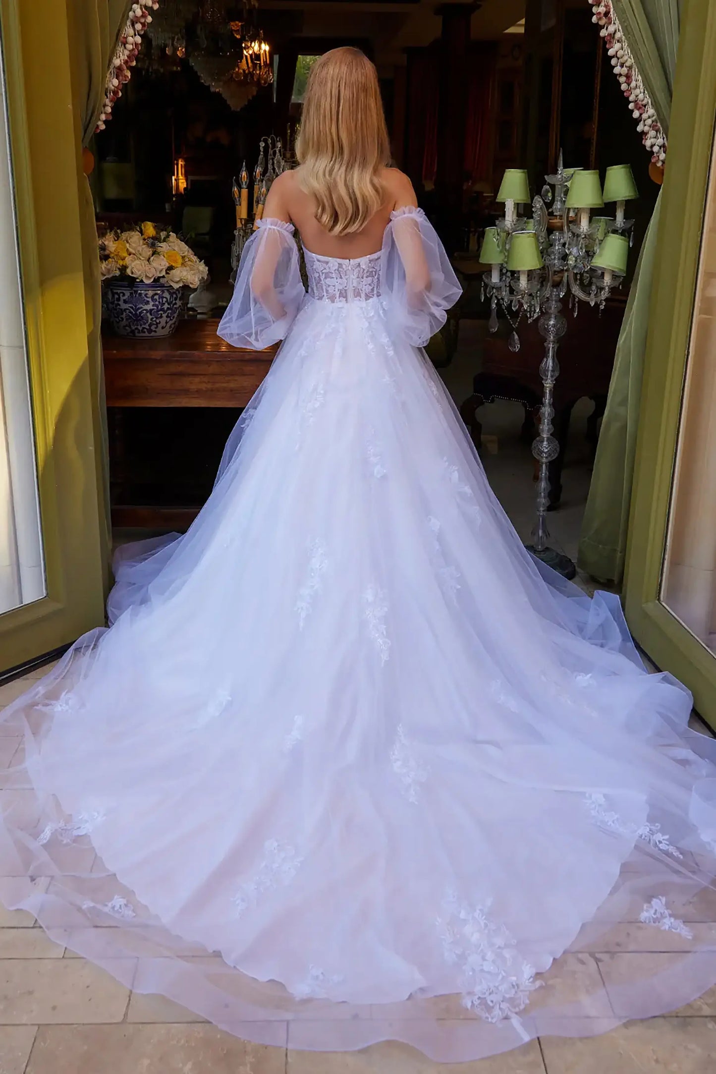 Back full-length view showcasing the elegant flow of the white A-line skirt and the full extension of the bridal train.