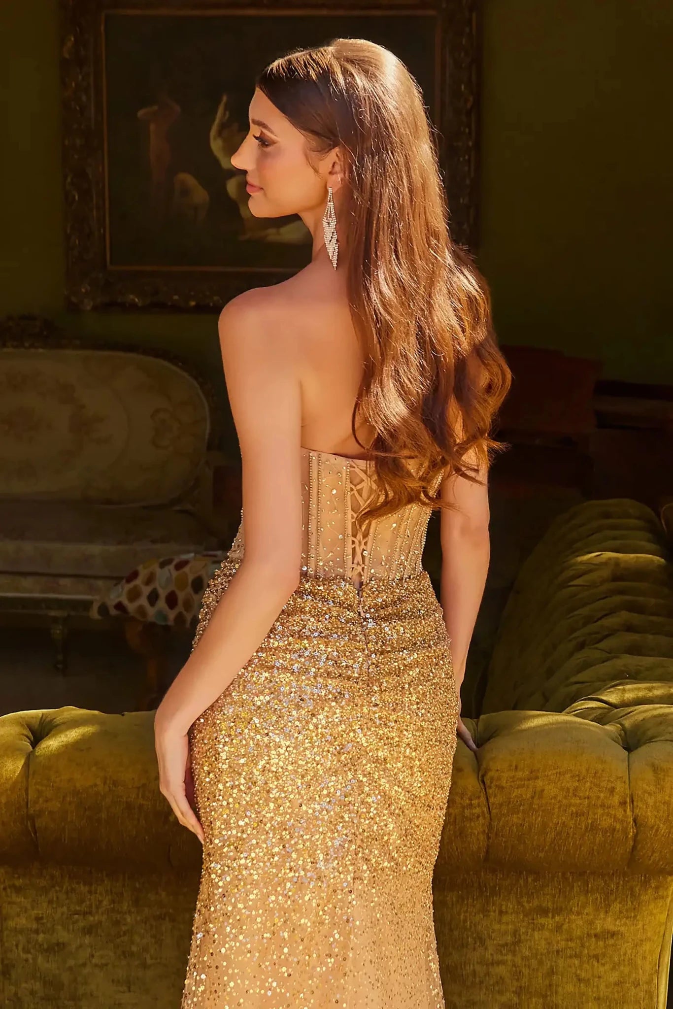 Back close-up upper view of Gold strapless beaded prom dress with v-neck corset and front slit