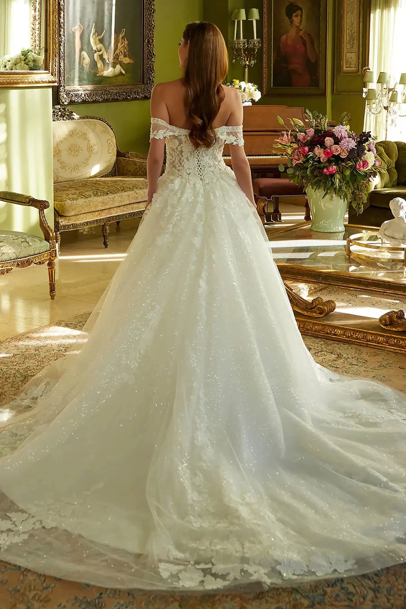 Back full-length view showcasing the elegant sweep of the embroidered mesh skirt and the full extension of the bridal train.