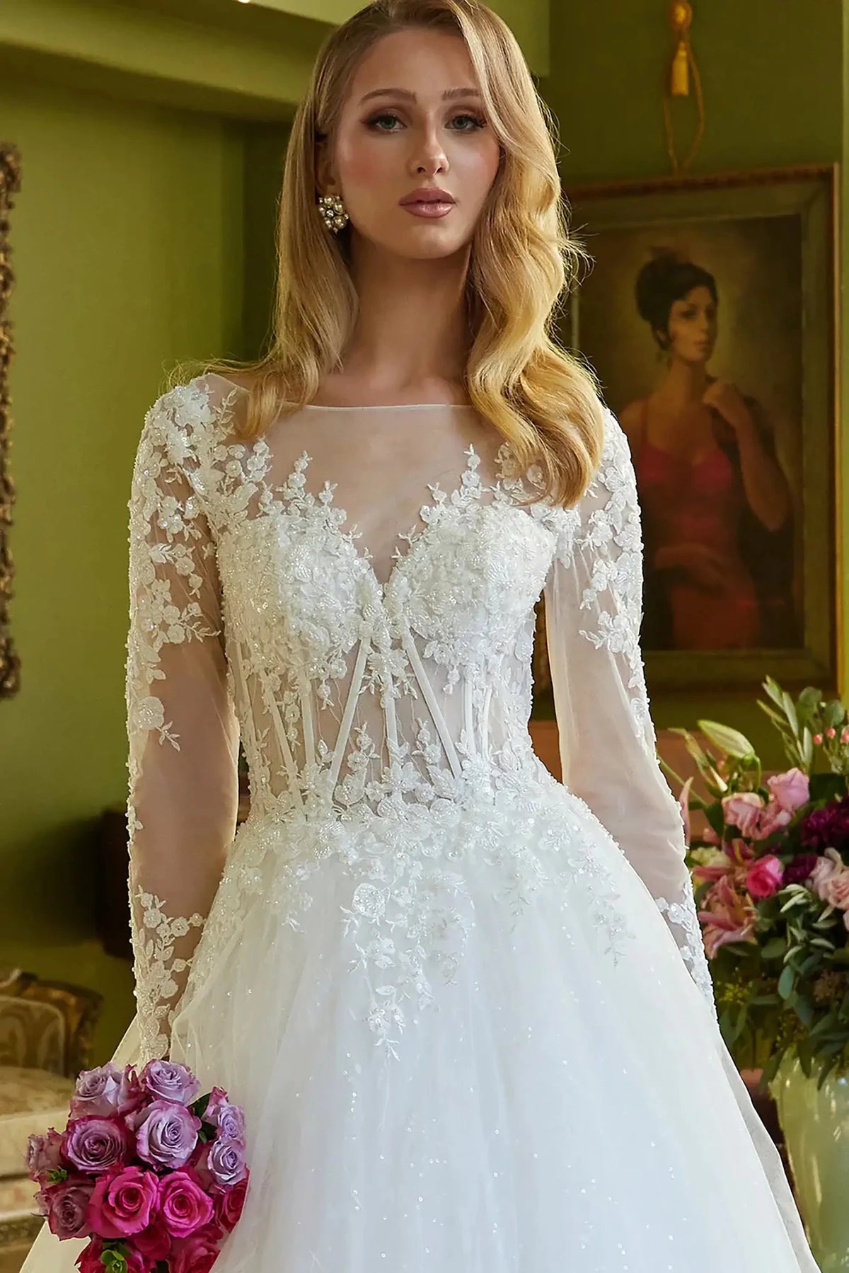 Close-up view reveals Off White wedding dress with the intricate beadwork on the structured corset.