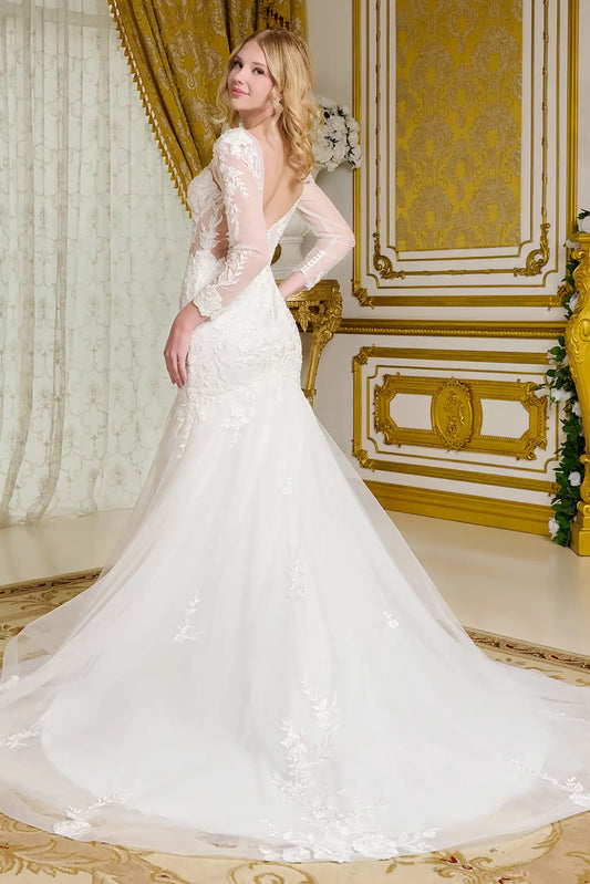 Woman in a white wedding dress standing in an ornate room with gold accents.