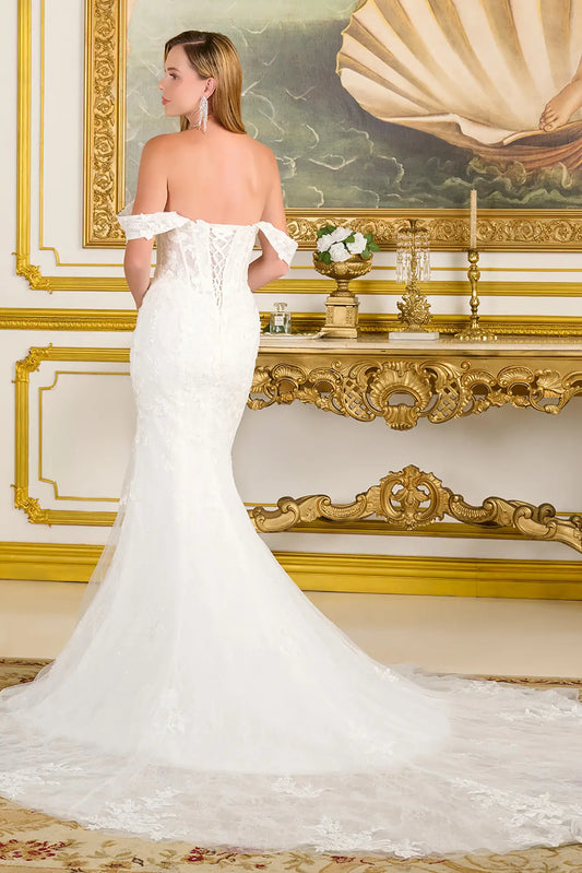 Woman wearing a wedding gown in a gold and white accent room