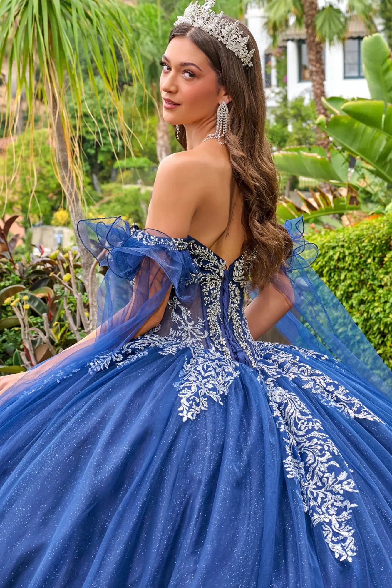 Navy quinceañera ball gown with lace-up back and beaded corset bodice, close-up back view outdoors