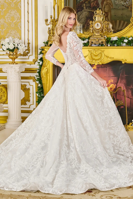 Back view of wedding gown with corset closure, sheer sleeves, and flowing train