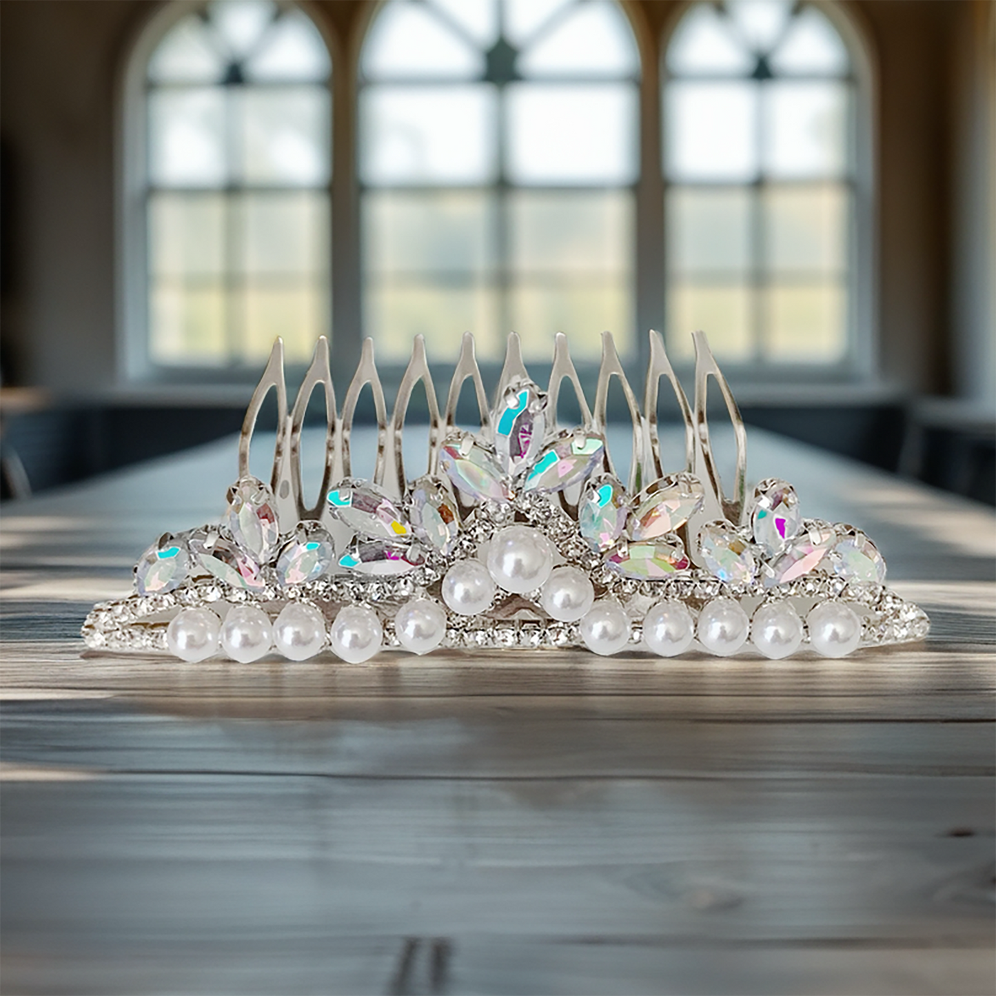 Decorative tiara with pearls and crystals on a wooden table