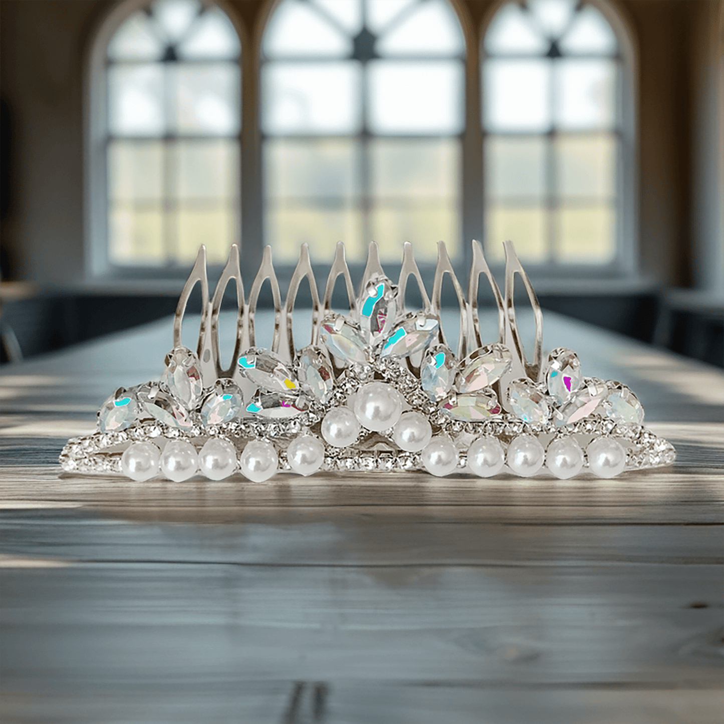 Decorative tiara with pearls and crystals on a wooden table