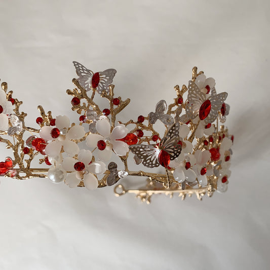 Decorative tiara with flowers and butterflies on a light background