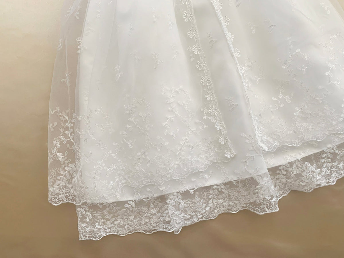 Bodice close-up highlights white lace fabric. Baby Vintage Communion dress. Also suitable as a baptism dress.