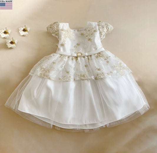 White lace dress on a beige background with small flowers.