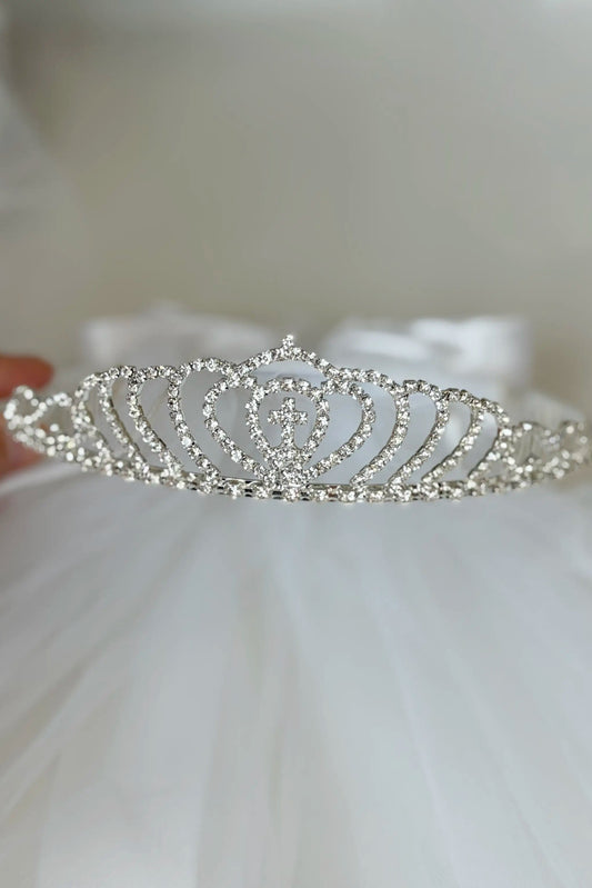 “The tiara features a cross at the center and is fully embellished with sparkling rhinestones.”