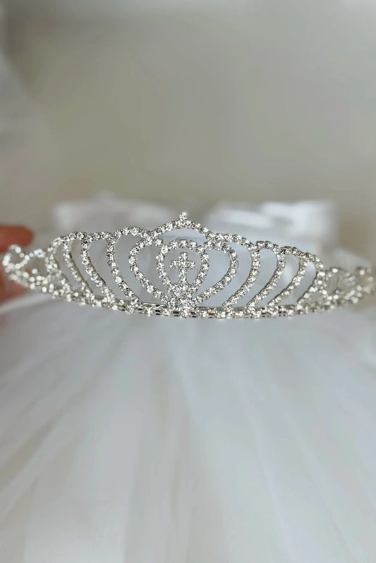 “The tiara features a cross at the center and is fully embellished with sparkling rhinestones.”