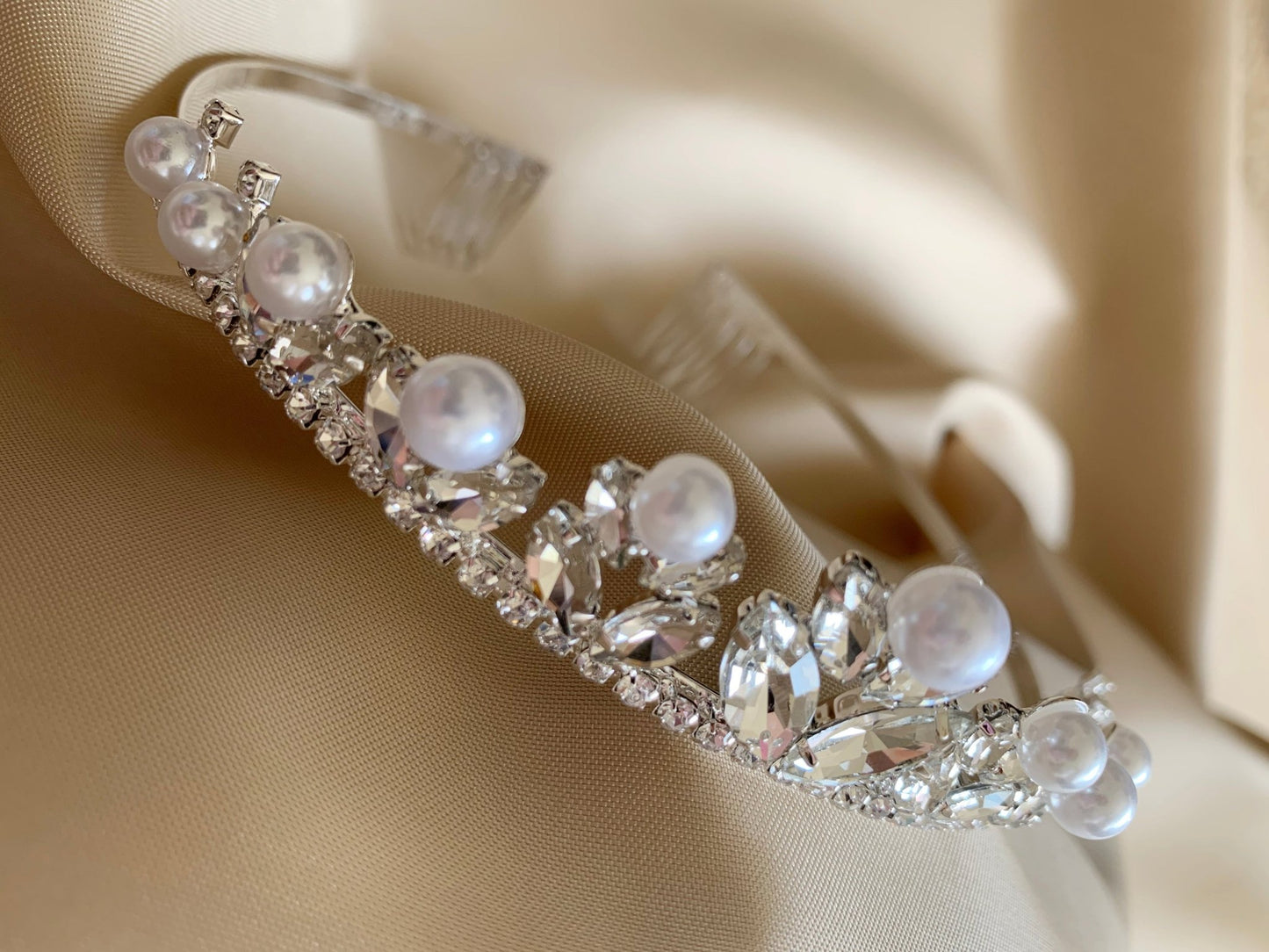 zoomed in view showcasing pearls on a clear rhinestone tiara
