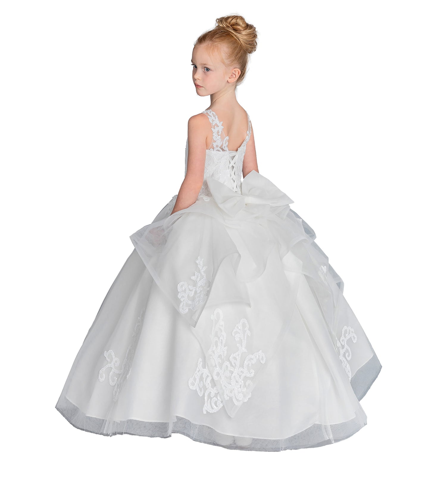 Young girl wearing a white floral dress on a white background