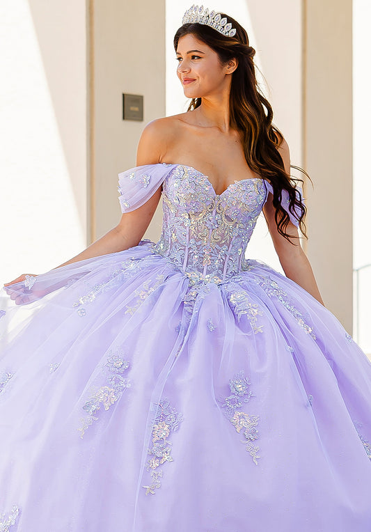 Quinceanera | Lilac Two-Tone See-Through Shimmering Sequins and 3D flowers Bodice Ballgown - front view of woman wearing dress and crown smiling of into the distance