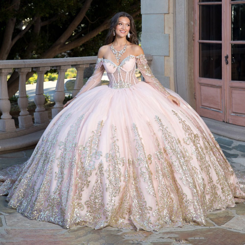 Detailed view highlights a Blush and gold quinceañera ball gown with corset bodice, rhinestones and glitter detailing.
