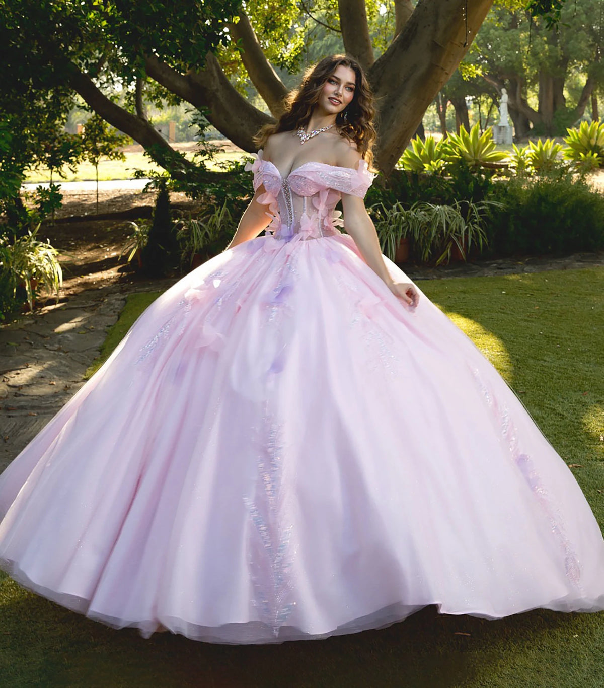 Detailed view highlights a pink and purple gown with corset bodice and layered tulle skirt.