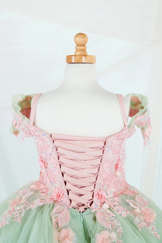 Close-up display highlighting the fitted bodice, detachable bow accent, and the shimmer of the glitter tulle layers.