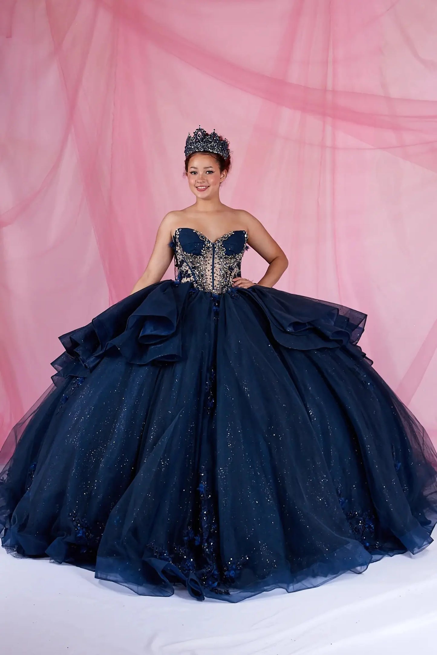Navy quinceanera ball gown with sweetheart neckline, bead accents, and fringe bodice detail