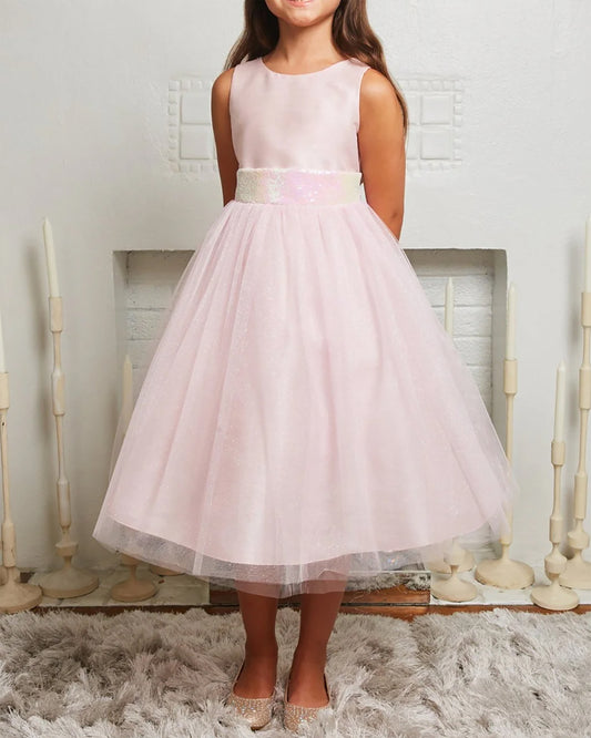 Pink dress worn by a young girl on a neutral background