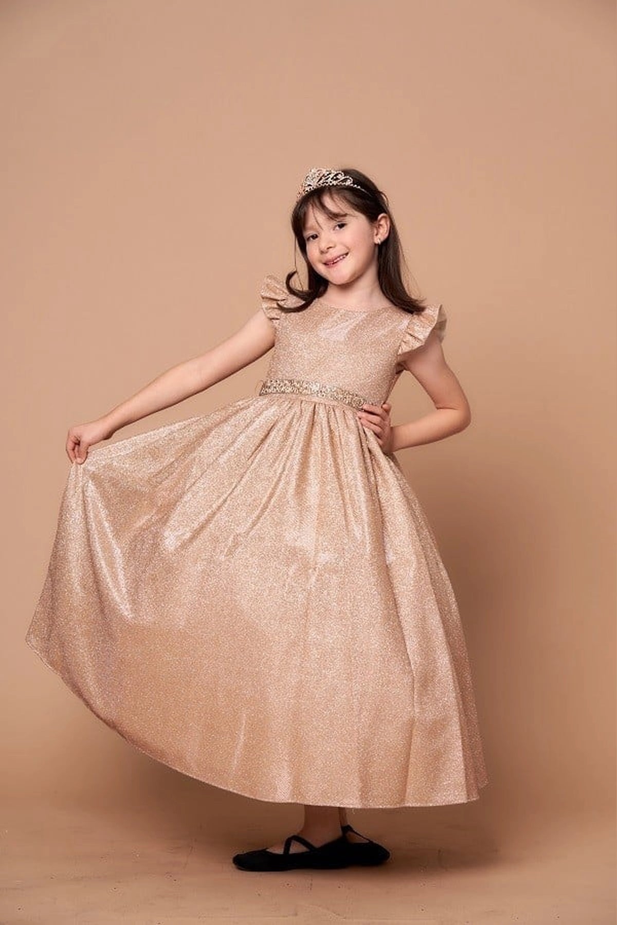 An alternate angle captures ruffle sleeves with a removable rhinestone belt on the Champagne mini quince dress.