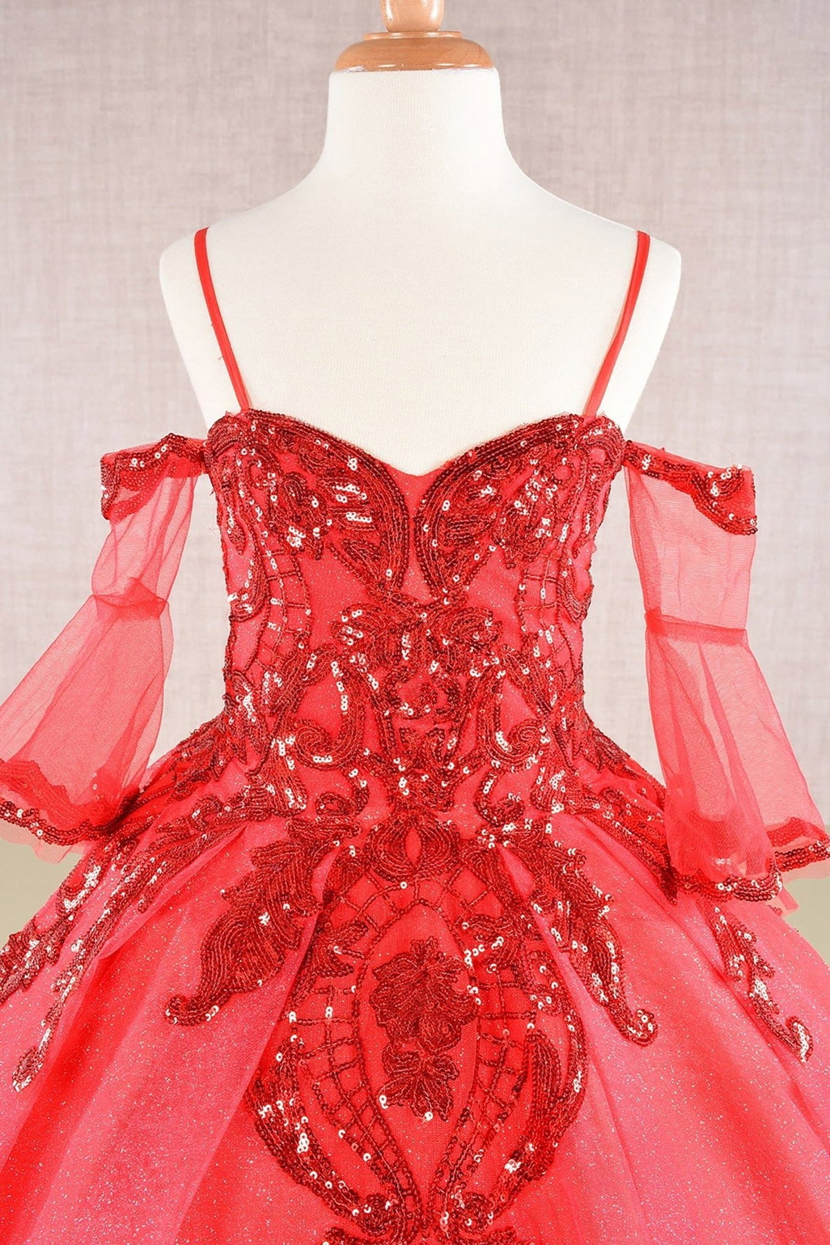 Close-up view reveals Red mini quince dress with a close-up of red glitter sequin mesh bodice.