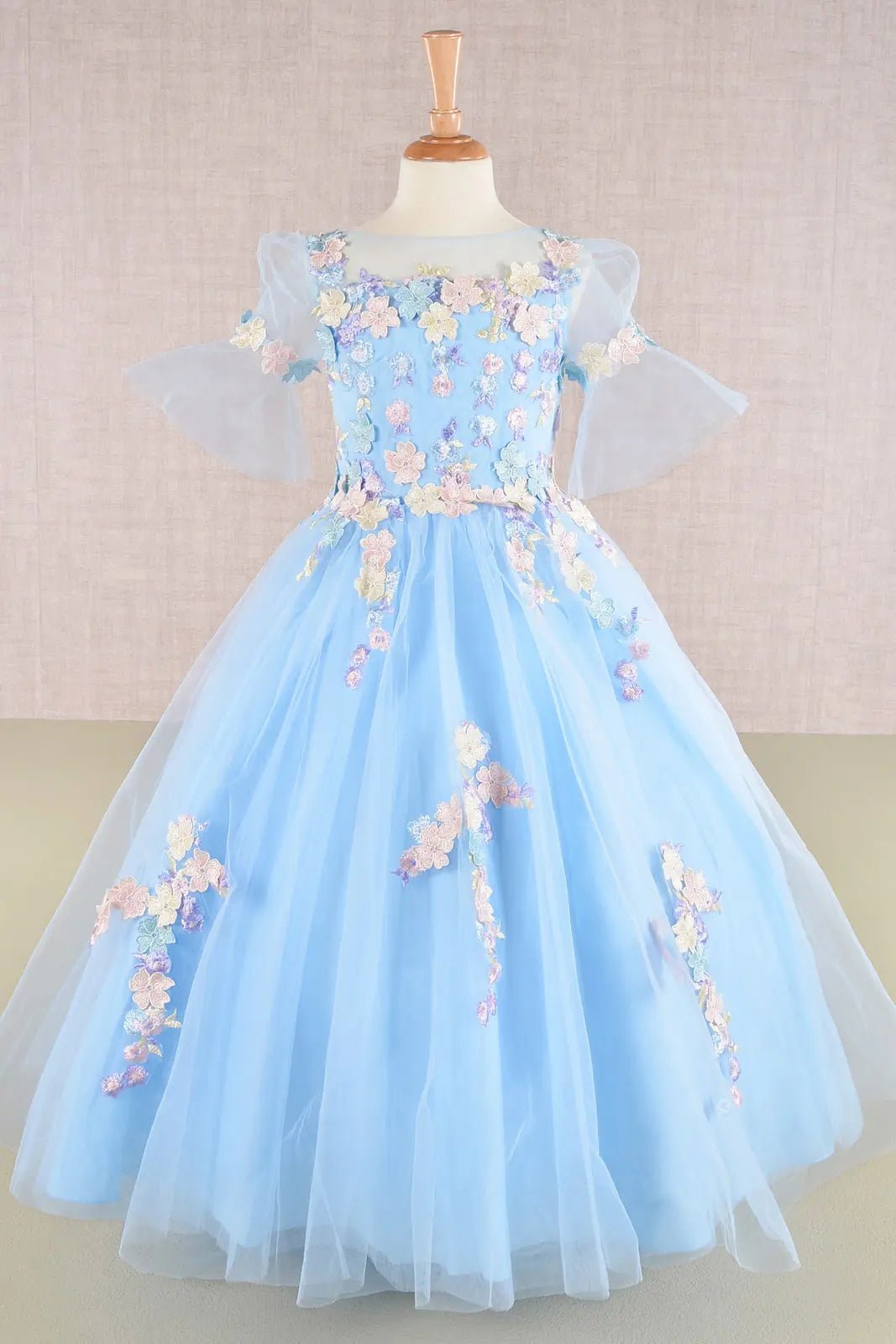 Back baby blue kid ballgown featuring layered skirt and extended back hem with floral appliques
