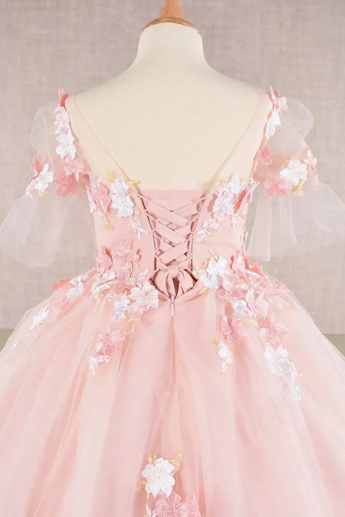 Close-up of Blush Kids Dress with 3D Floral Applique, Puff Sleeves and Back Hem, Mini Quince Dress.
