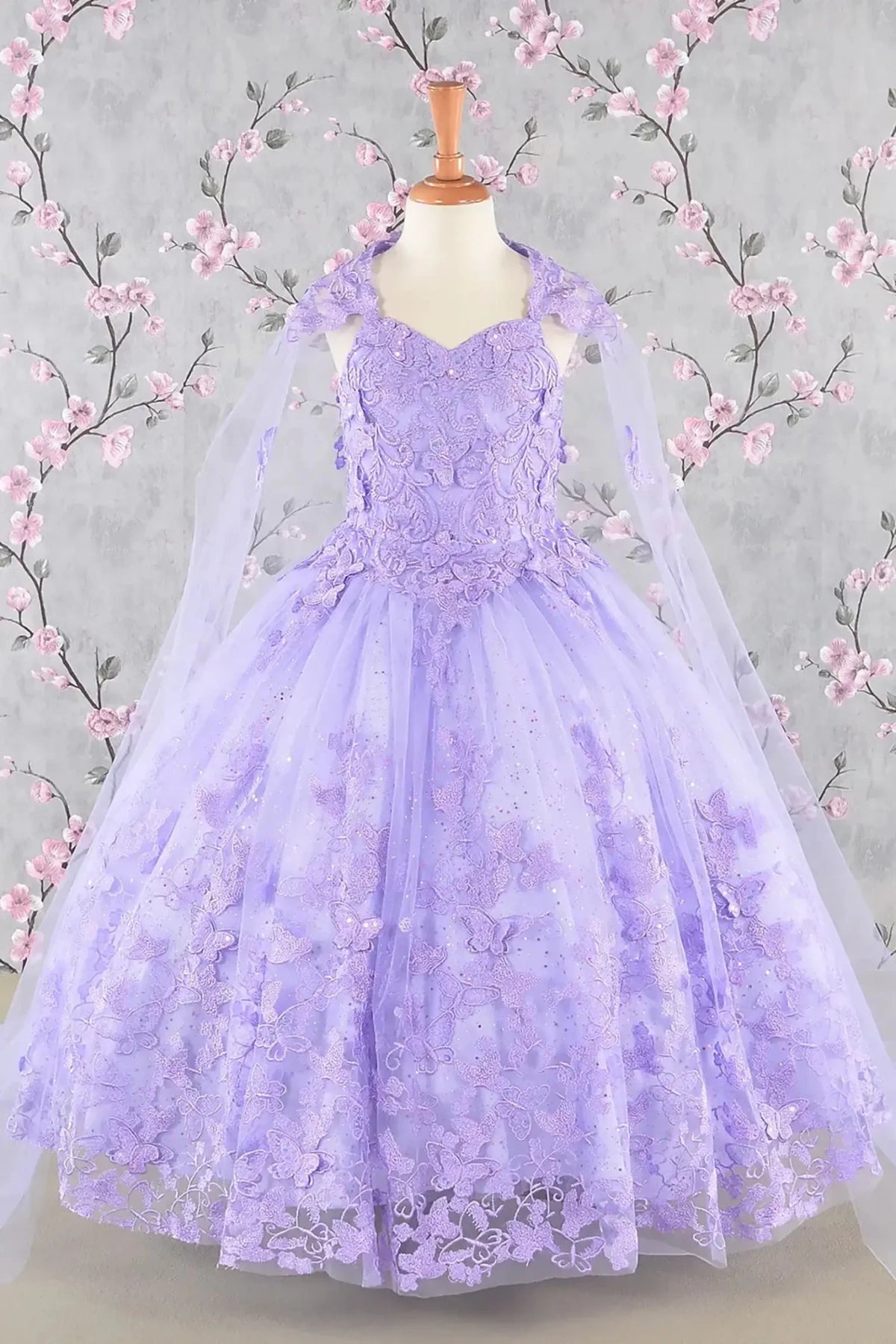 Bodice close-up highlights lilac kids mini quinceañera mini quince dress with 3D butterfly appliques, sequin-embellished bodice.