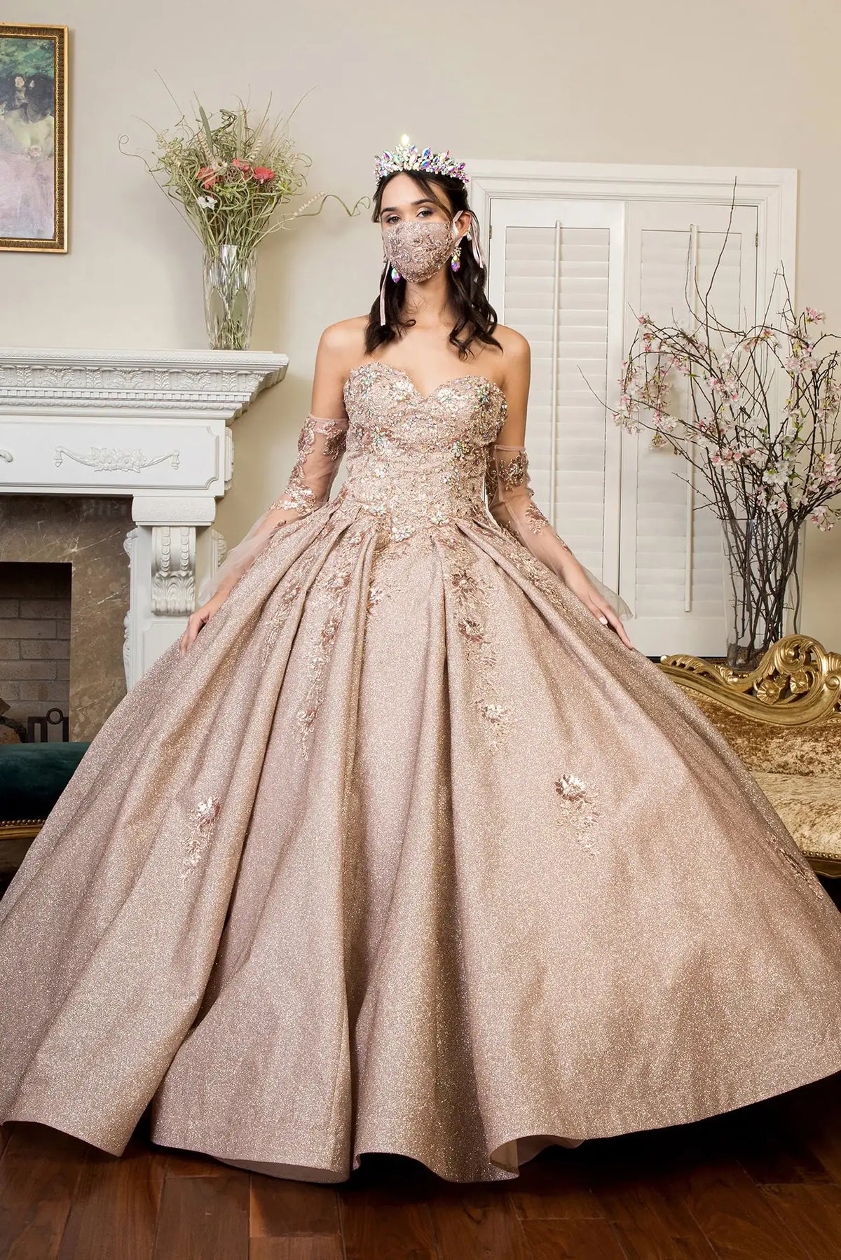 Layered skirt showcases the Rose Gold quinceañera ball gown with ruffled train.