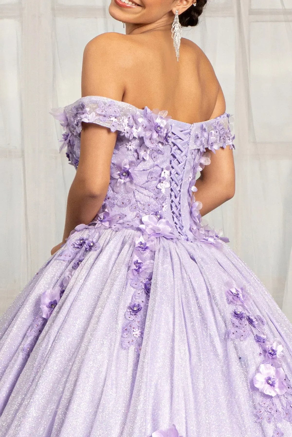 Layered skirt showcases the Lilac quinceañera ball gown with 3d floral appliqués.