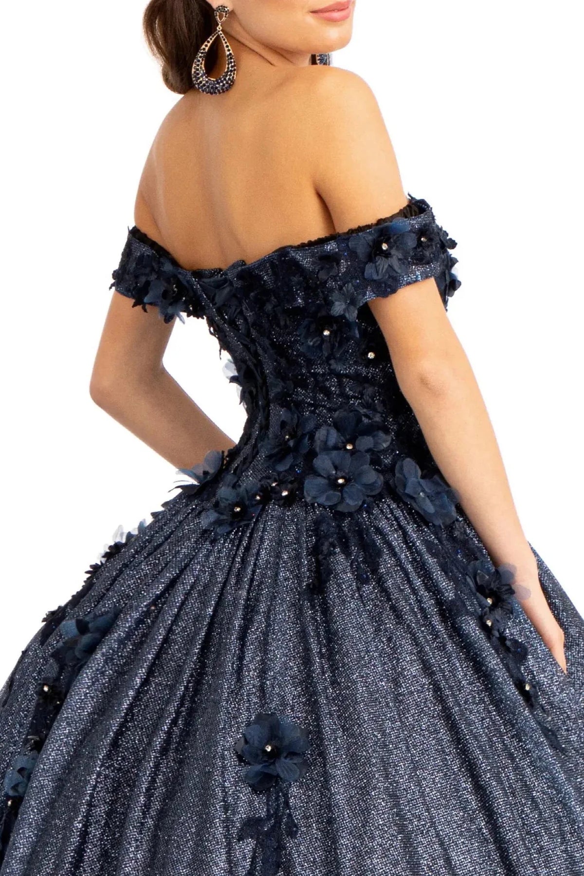 Layered skirt showcases the Navy quinceañera ball gown with 3d floral appliqués.