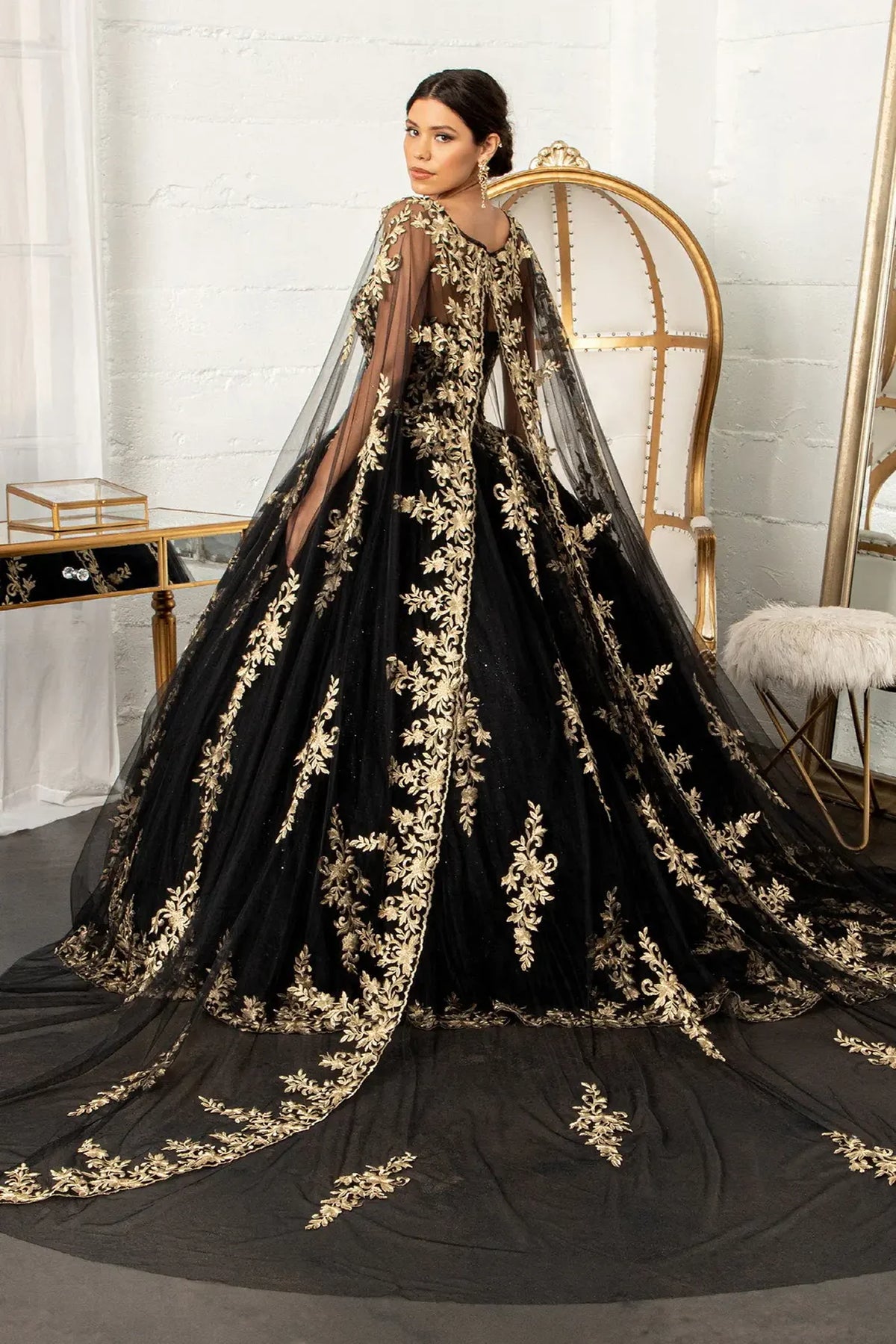 Embroidered details frame the Black quinceañera ball gown with embroidered mesh cape.