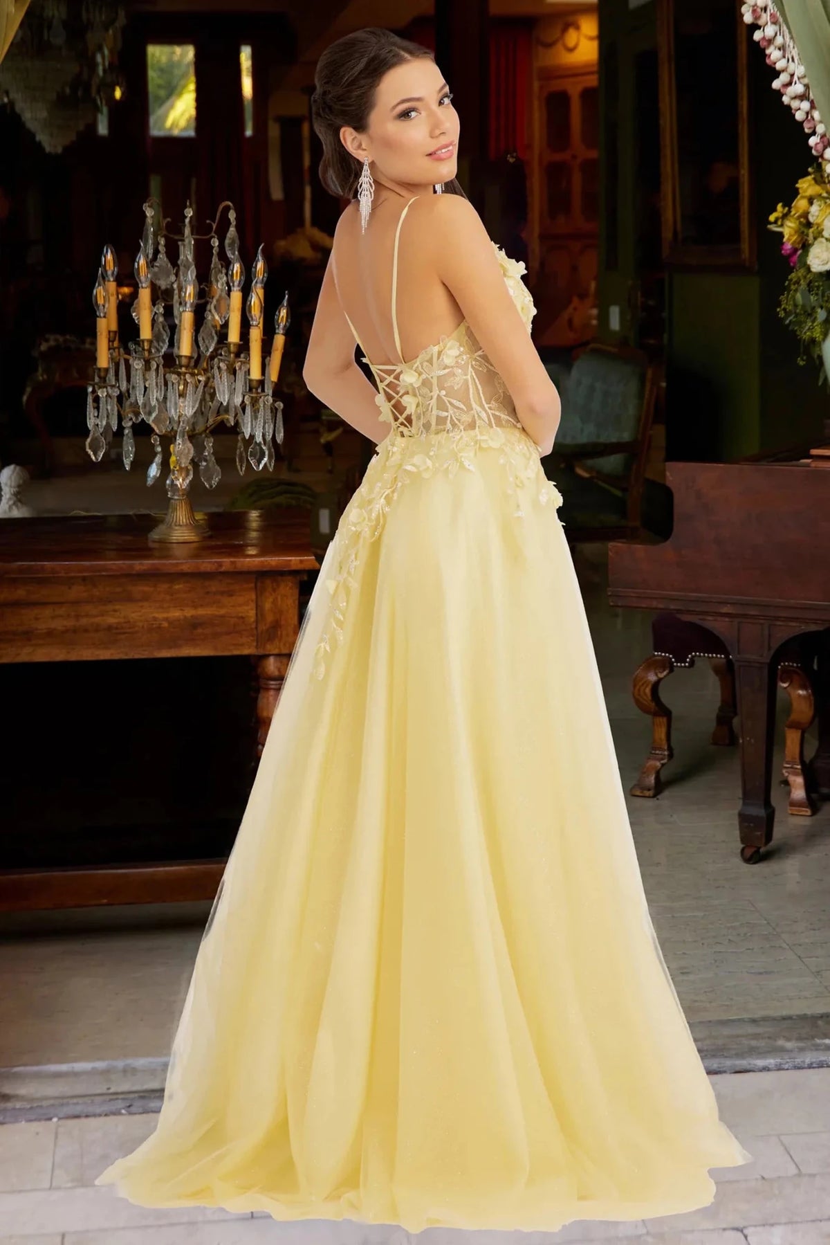 Rear view reveals yellow 3d floral corset mother of the bride dress.