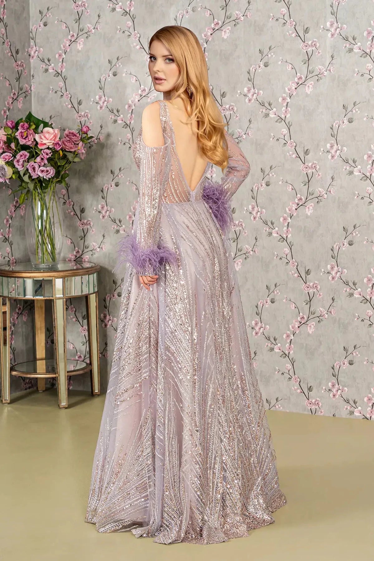 Rear view reveals lilac sequin feather sleeve mother of the bride dress.