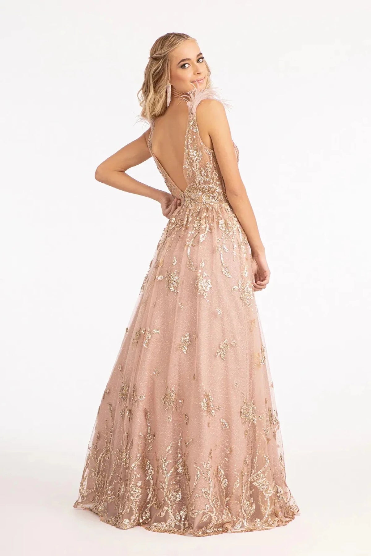 Rear view reveals mauve mesh sequin feather shoulder mother of the bride dress.