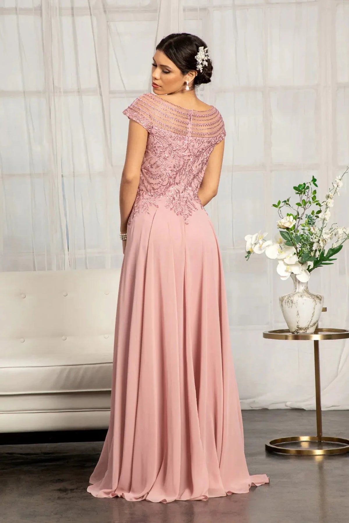 Rear view reveals dusty Rose a-line mother of the bride dress with concealed zipper back and cap sleeve.
