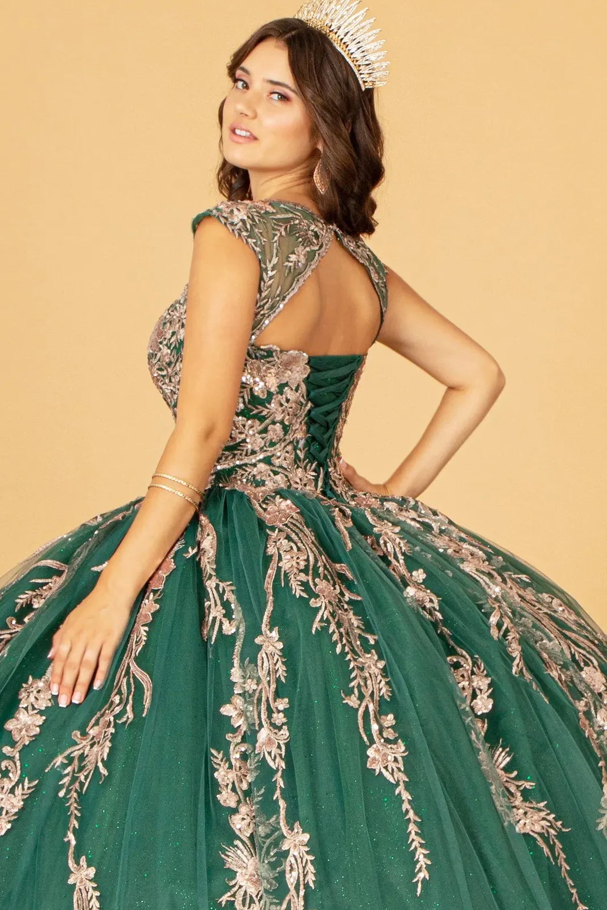 Embroidered details frame the Green quinceañera ball gown with gold metallic embroidery.