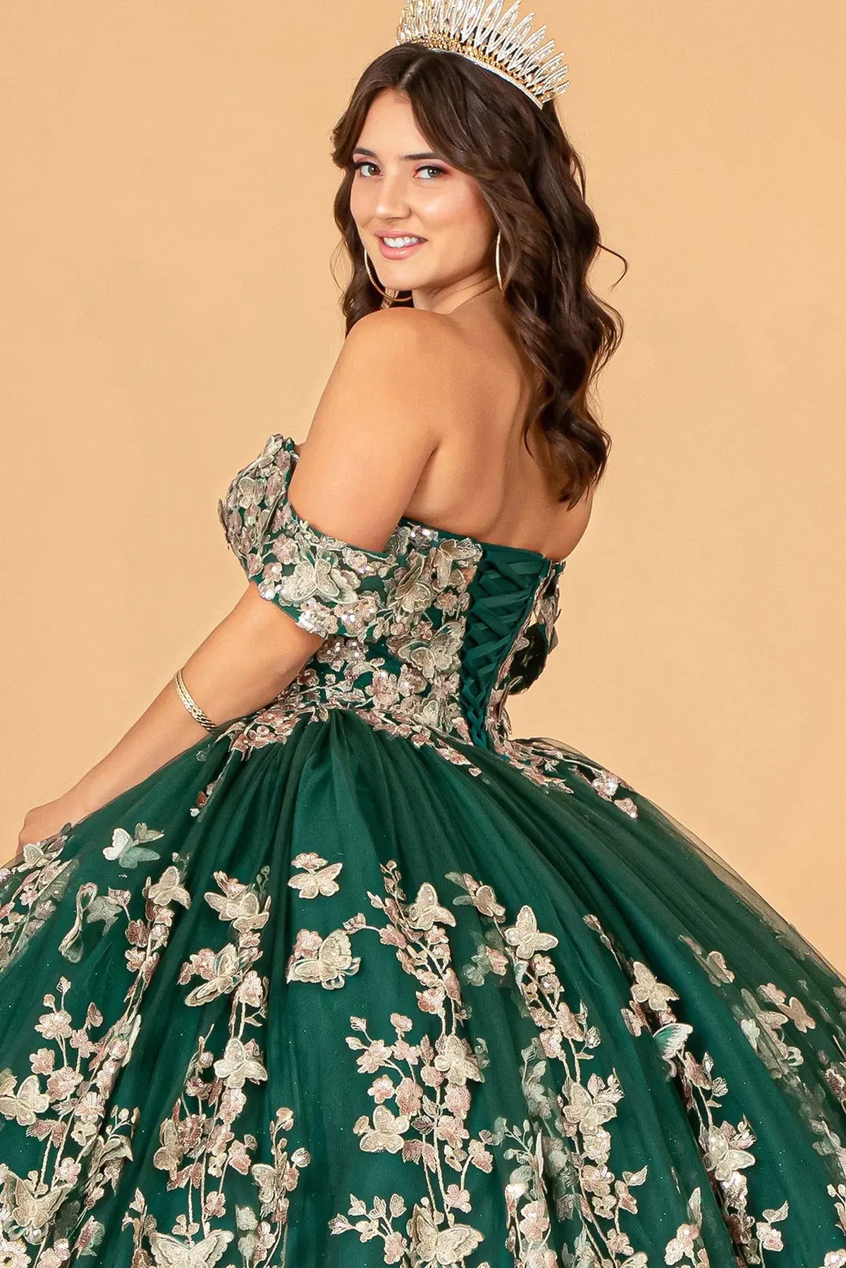 Layered skirt showcases the Green quinceañera ball gown with 3d butterfly appliqués.