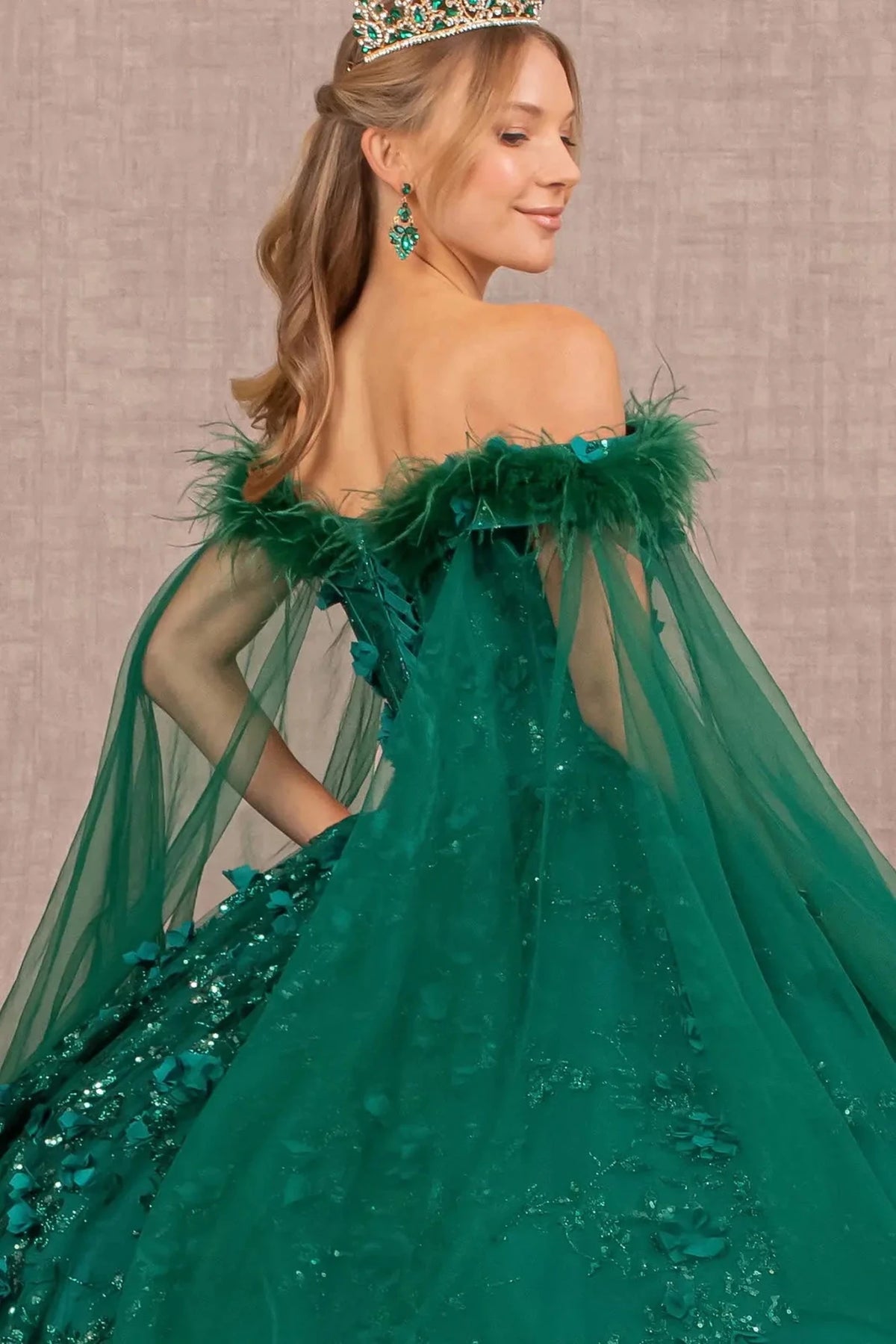 Embroidered details frame the Green quinceañera ball gown with detachable feather trim.