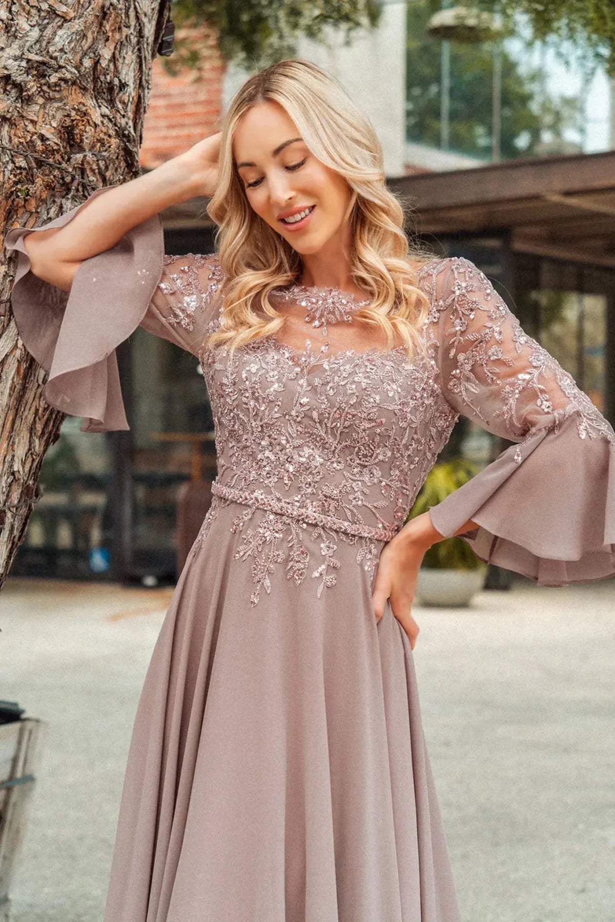 Detailed view highlights mauve mother of the bride dress featuring chiffon skirt with a-line shaping and beads, embroidery, sequin.