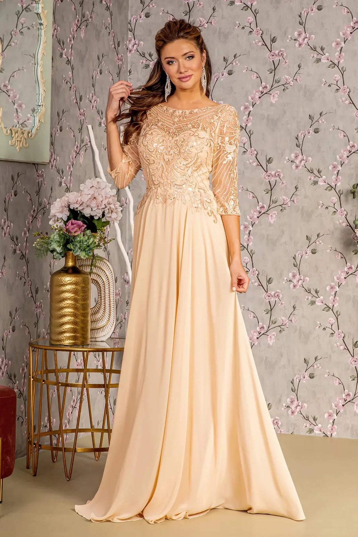 Detailed view highlights champagne chiffon a-line mother of the bride dress with boat-neck.