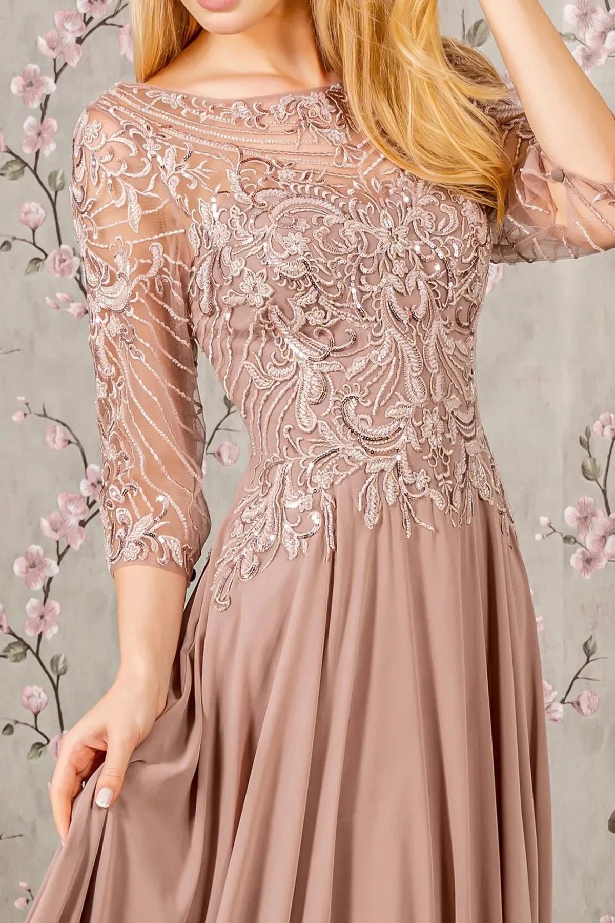 Rear view reveals mauve a-line mother of the bride dress with v-back with concealed zipper and 3/4 sleeve.