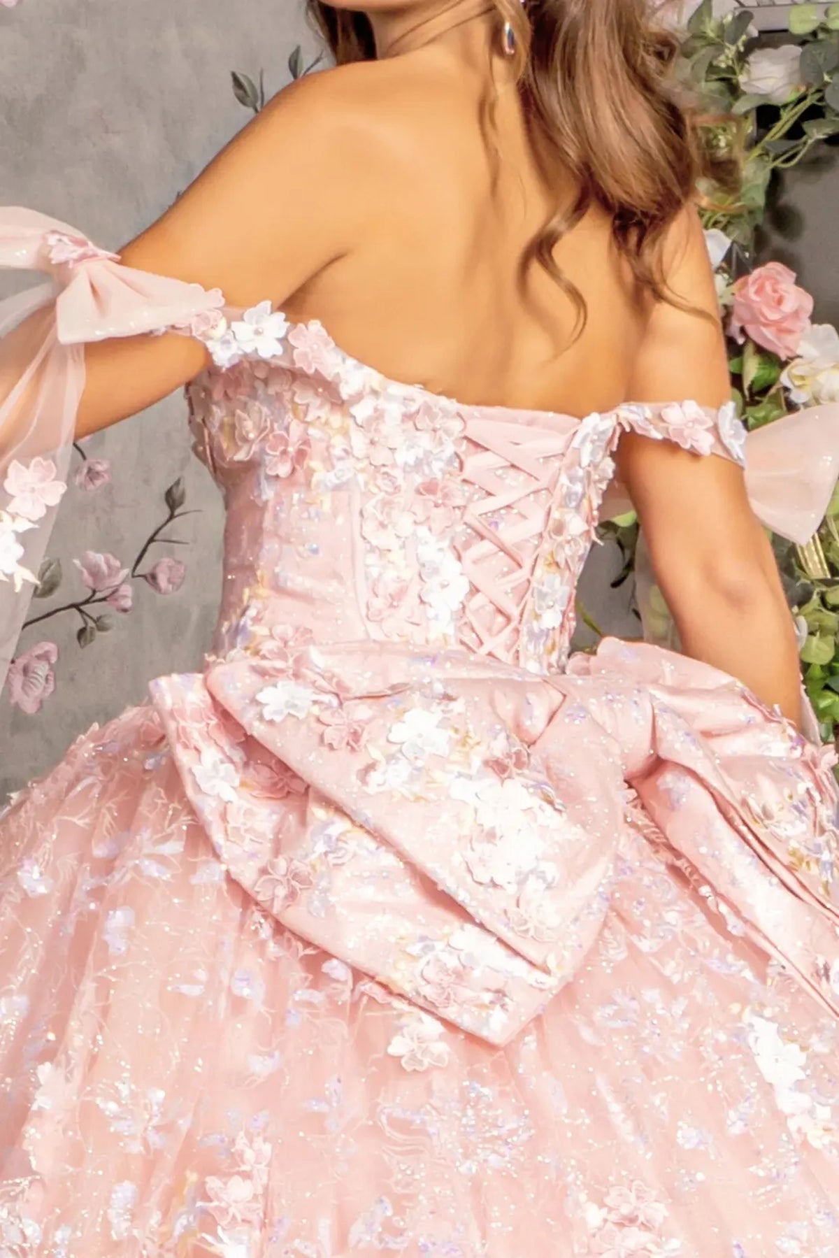 Detachable accents complete the Blush quinceañera ball gown with detachable ribbons.