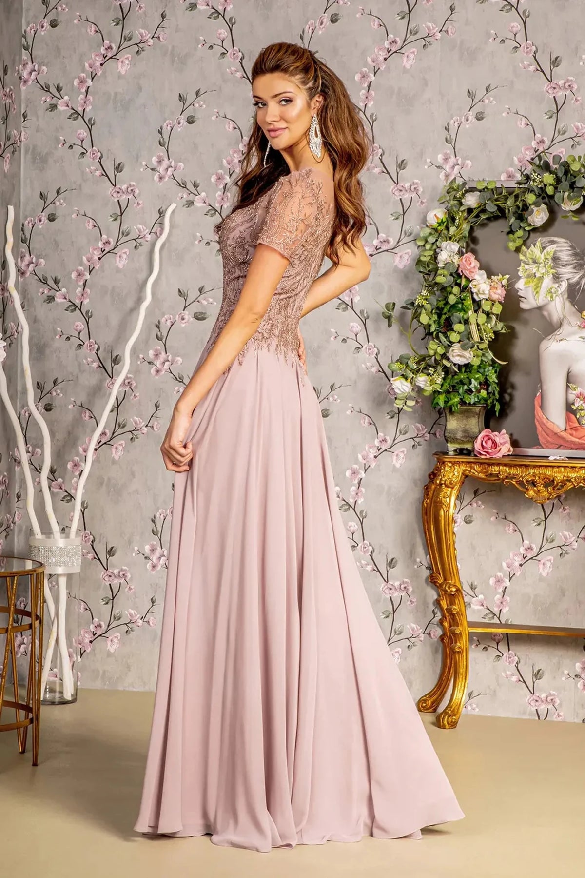 Rear view reveals mauve a-line mother of the bride dress with concealed zipper back and short sleeve.