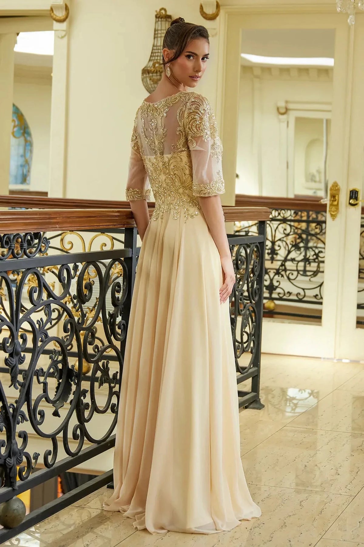 Rear view reveals champagne a-line mother of the bride dress with concealed zipper back and 1/2 sleeve.