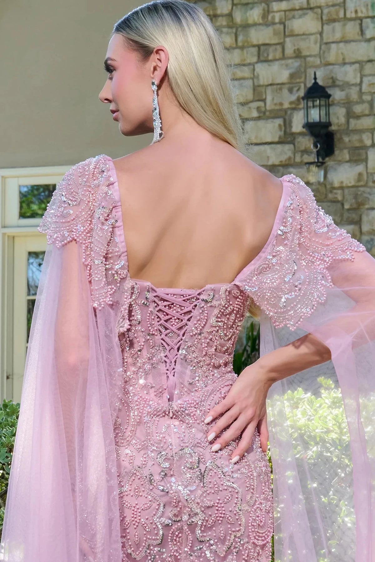 Back detail shows dusty Rose mother of the bride dress featuring corset back bodice finished with beads, sequin.