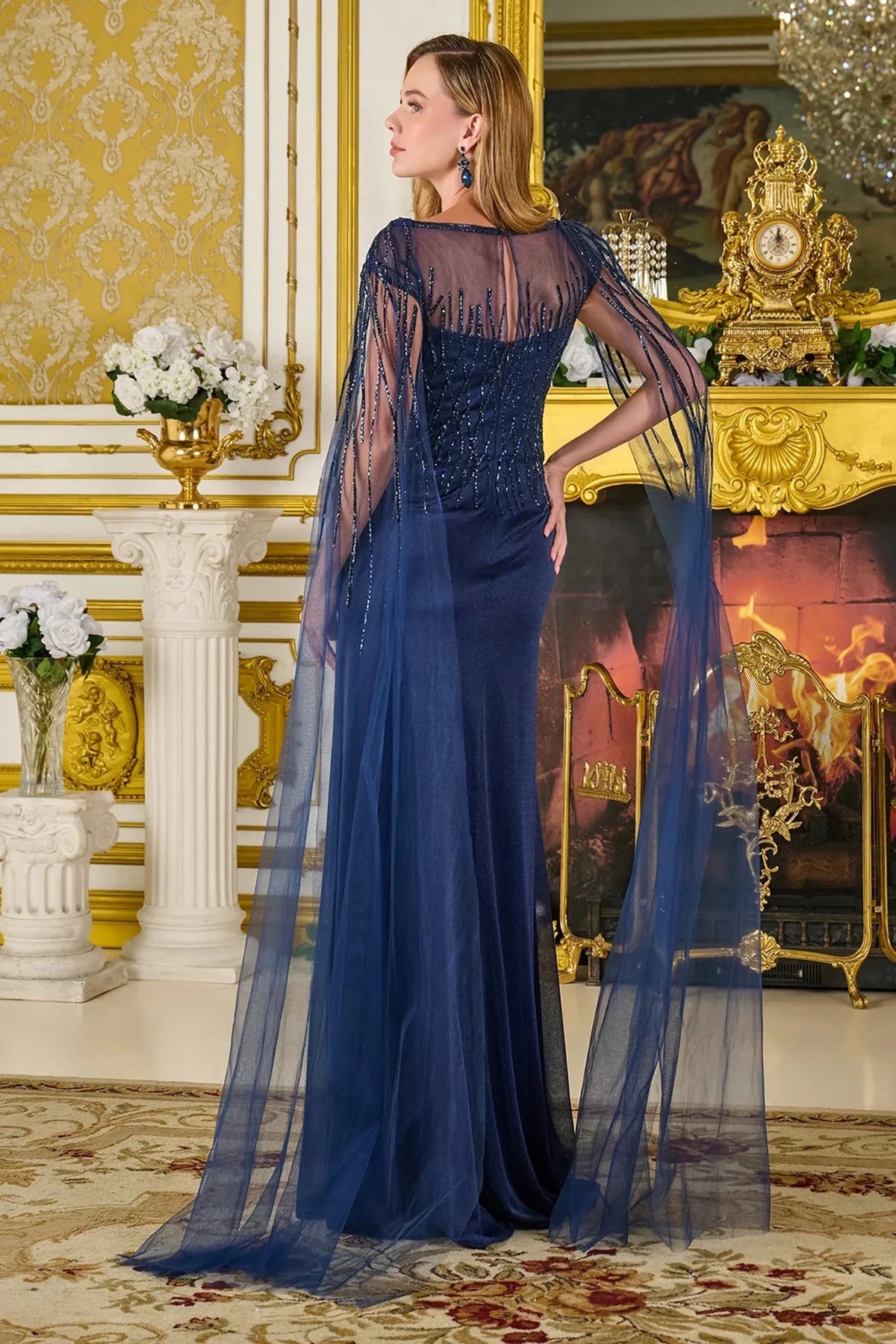 Rear view reveals Navy Embellished a-line mother of the bride dress with concealed zipper back and cape sleeve.