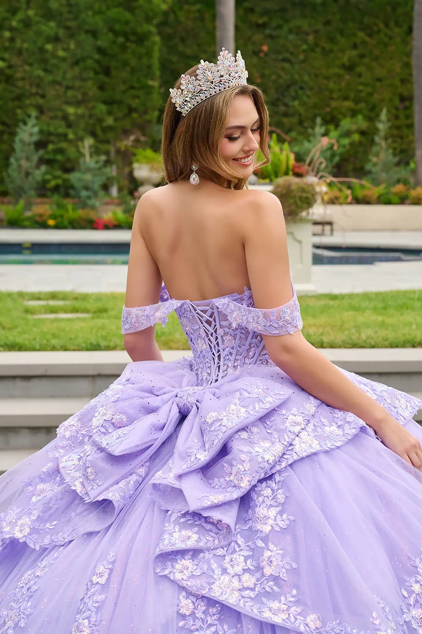 Lilac quinceañera ball gown refined with detachable bow detail and radiant corset embellishments
